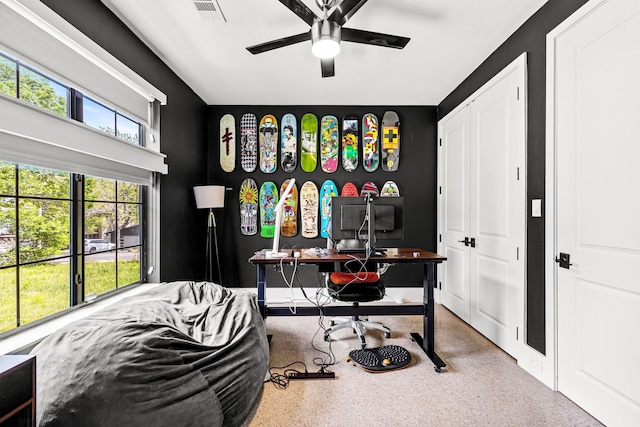 office space with a ceiling fan, visible vents, and speckled floor