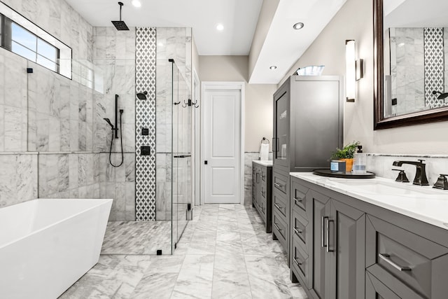 full bath featuring recessed lighting, a shower stall, vanity, marble finish floor, and a soaking tub