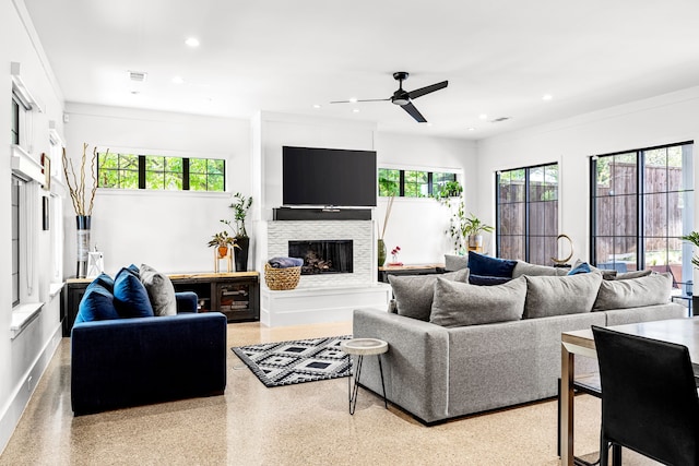 living area with visible vents, speckled floor, recessed lighting, a fireplace, and a ceiling fan