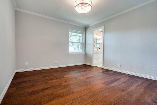 empty room featuring baseboards, dark wood-style flooring, and crown molding