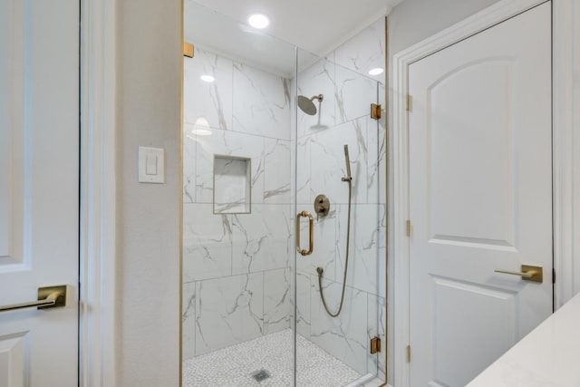 bathroom featuring recessed lighting and a marble finish shower