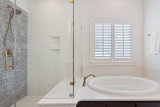 full bathroom with a shower stall and a bath