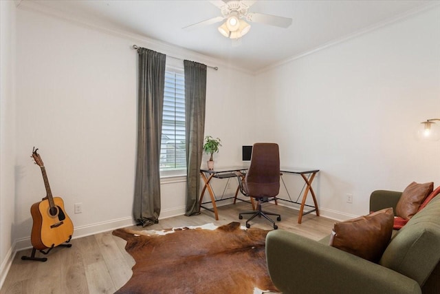 office space featuring crown molding, ceiling fan, wood finished floors, and baseboards