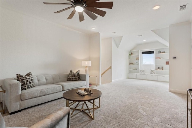 living area with baseboards, visible vents, a ceiling fan, and carpet flooring