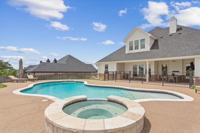 view of pool featuring a pool with connected hot tub, a fenced backyard, and a patio area