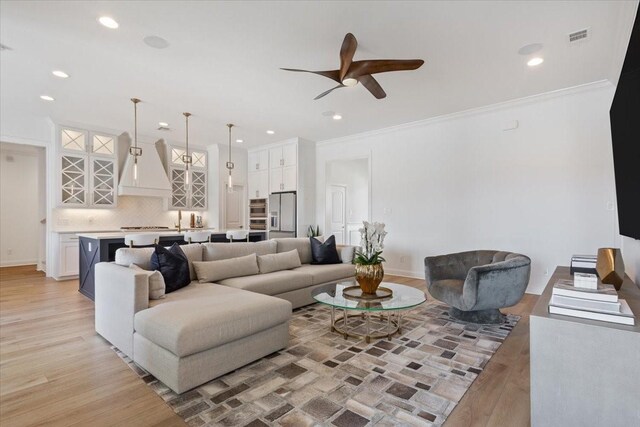 living area with recessed lighting, visible vents, ceiling fan, and light wood-type flooring