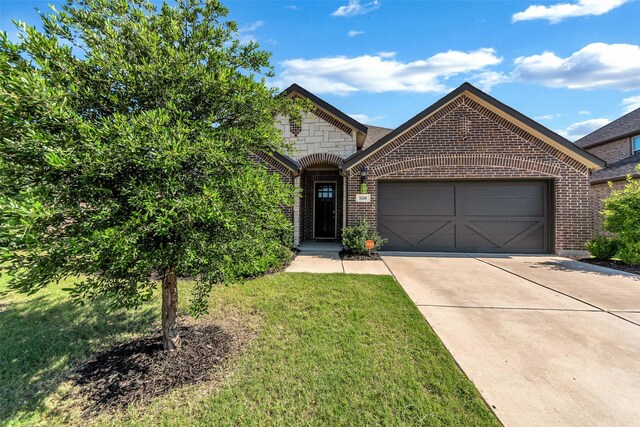 1116 Quail Dove Dr, Little Elm, TX 75068 - french country home featuring brick siding, an attached garage, driveway, and a front yard