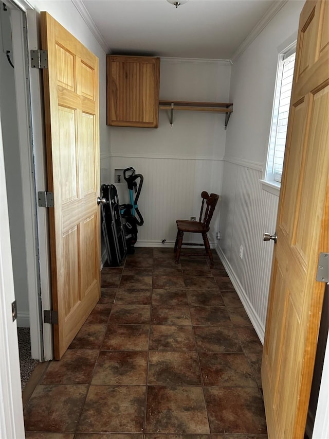 hall with ornamental molding and wainscoting
