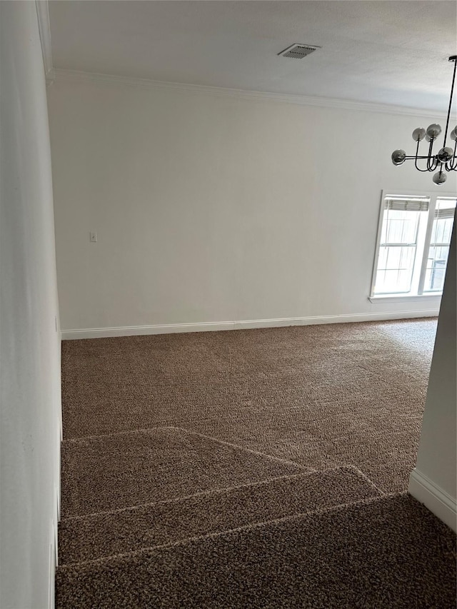 carpeted empty room with crown molding, baseboards, a notable chandelier, and visible vents