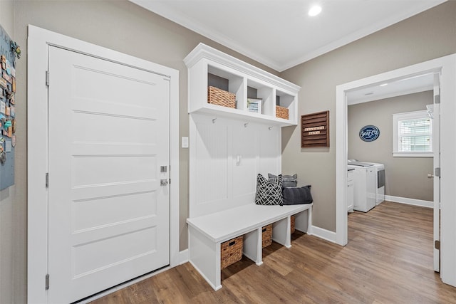 mudroom featuring baseboards, washer and clothes dryer, ornamental molding, recessed lighting, and wood finished floors