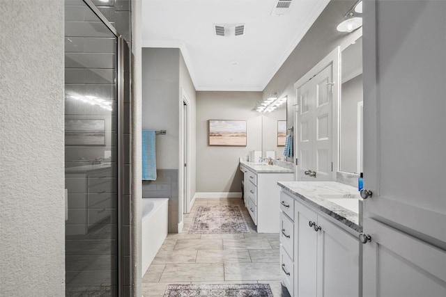 bathroom with ornamental molding, a bath, two vanities, and a shower stall