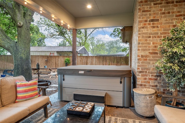 view of patio / terrace featuring a fenced backyard and a hot tub