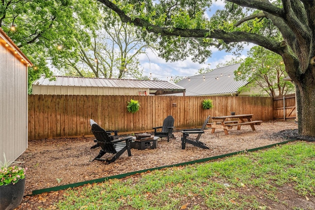 view of yard with an outdoor fire pit and a fenced backyard