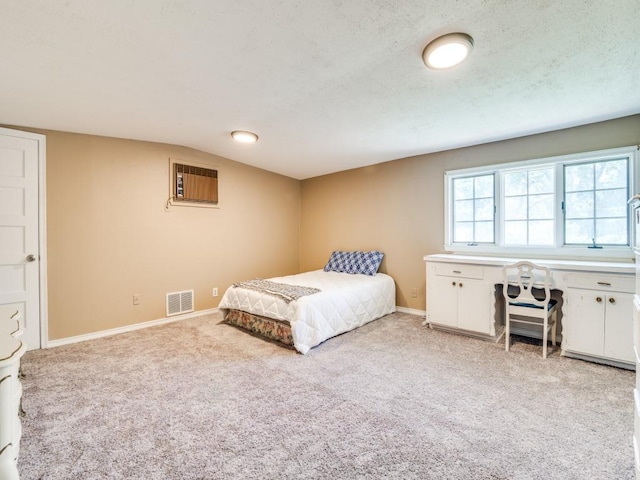 bedroom featuring baseboards, visible vents, light carpet, and an AC wall unit