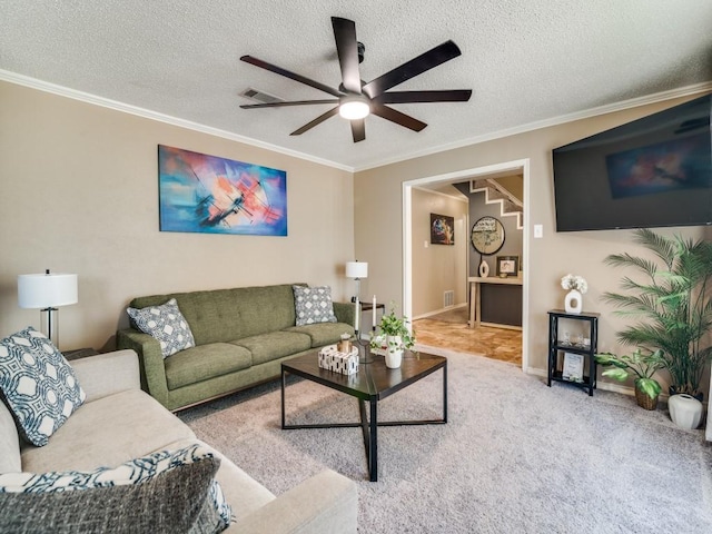 living room featuring crown molding, a ceiling fan, carpet, and baseboards