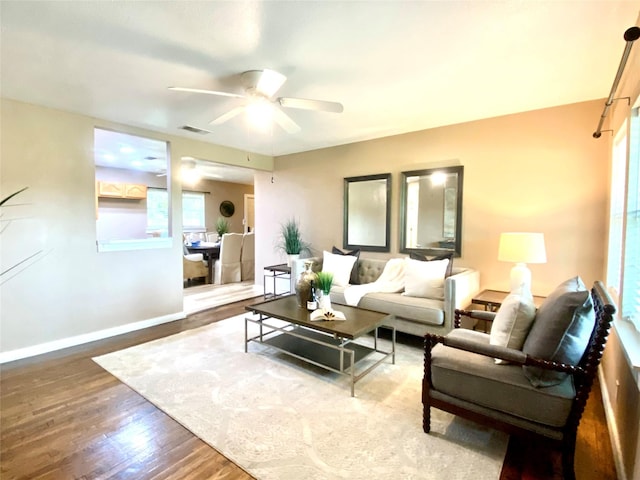 102 S Oak St, Paradise, TX 76073 - living area featuring wood finished floors, a ceiling fan, and plenty of natural light