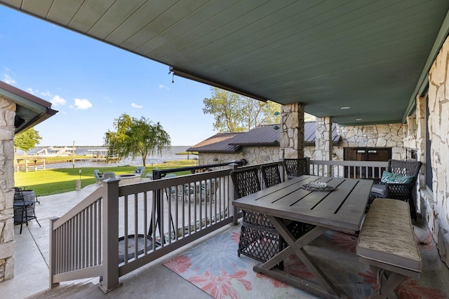 view of patio / terrace with outdoor dining area and a water view