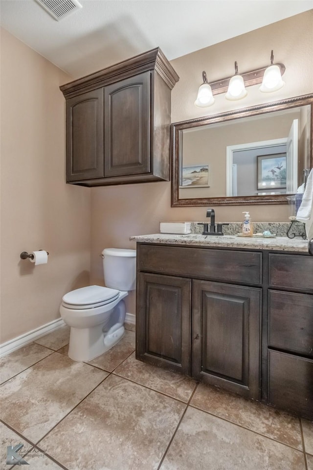 4917 Velta Ln, Abilene, TX 79606 - bathroom featuring tile patterned flooring, vanity, toilet, baseboards, and visible vents