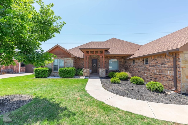 4917 Velta Ln, Abilene, TX 79606 - view of front facade featuring roof with shingles, a front lawn, and brick siding