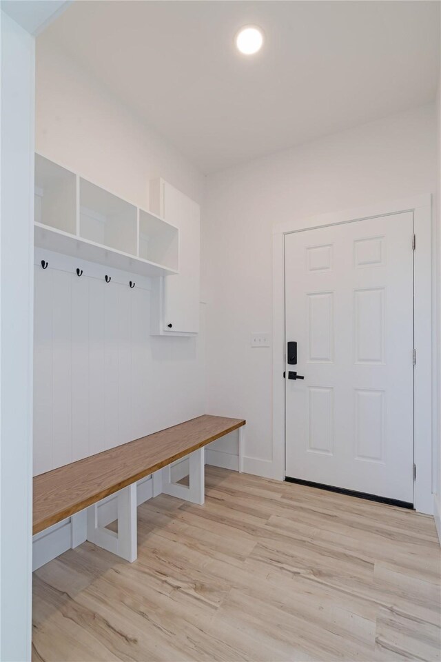 mudroom with baseboards and light wood-style floors