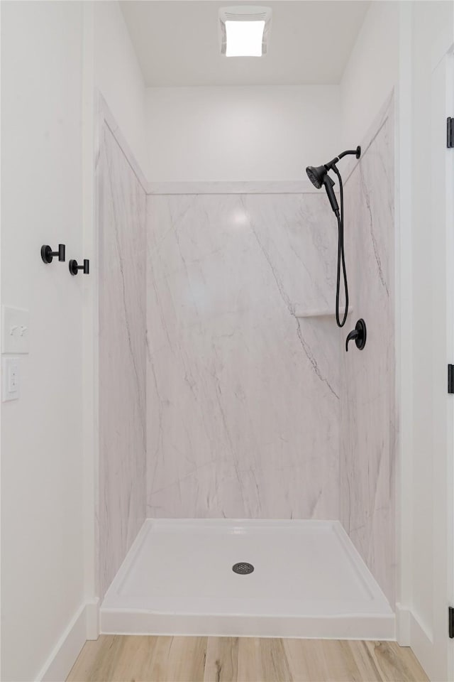 full bath featuring a marble finish shower
