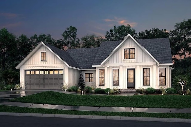 modern inspired farmhouse featuring a lawn, a shingled roof, driveway, and an attached garage