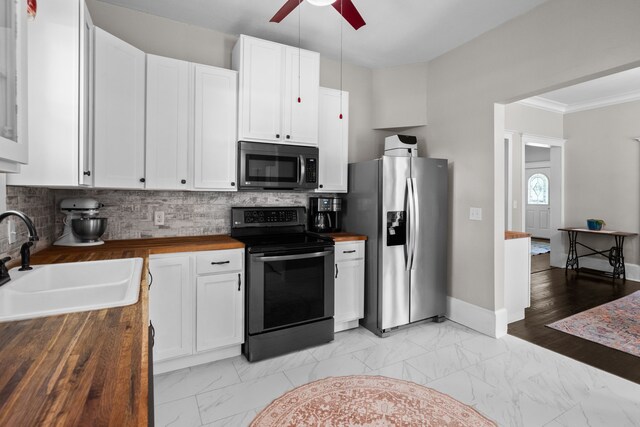 kitchen featuring a sink, wooden counters, electric range, stainless steel refrigerator with ice dispenser, and a ceiling fan