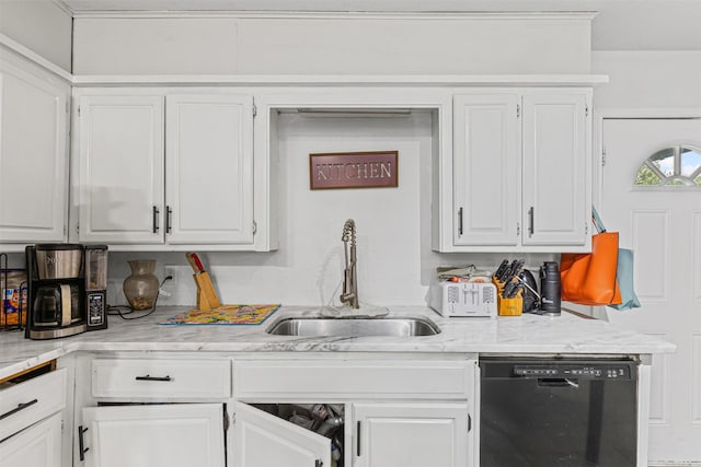 kitchen featuring white cabinets, light stone counters, dishwasher, and a sink