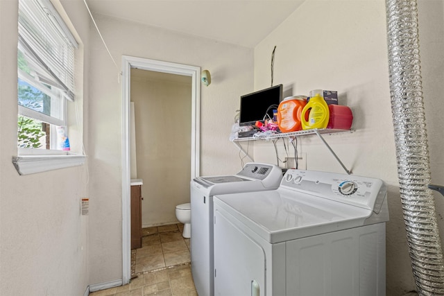 clothes washing area with washing machine and clothes dryer and laundry area