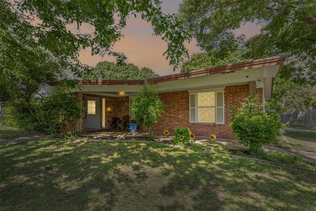 view of front facade featuring a front yard and brick siding