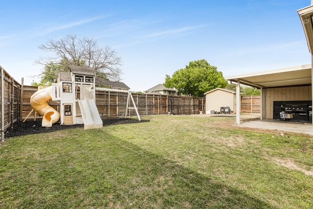 view of yard with a fenced backyard and a playground