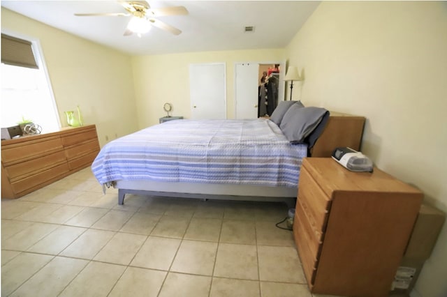 bedroom with light tile patterned flooring, ceiling fan, and visible vents