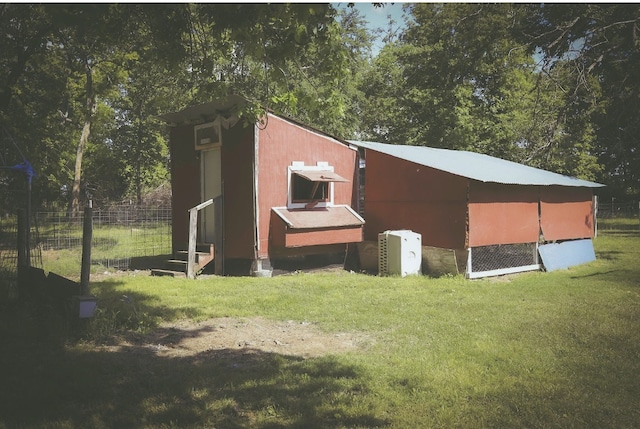 exterior space featuring fence and an outbuilding
