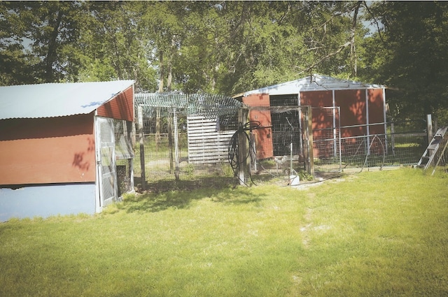 view of poultry coop with fence and a lawn