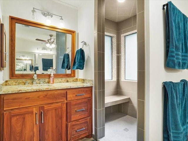 1428 Oxford Ln, Denton, TX 76209 - full bathroom featuring a ceiling fan, ornamental molding, tiled shower, and vanity