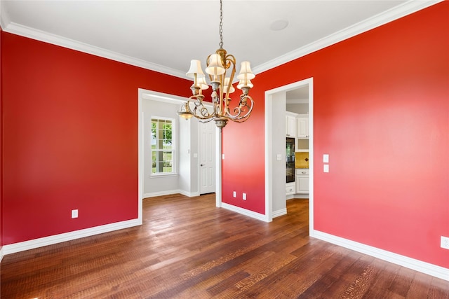 unfurnished dining area with dark wood-type flooring, a chandelier, ornamental molding, and baseboards