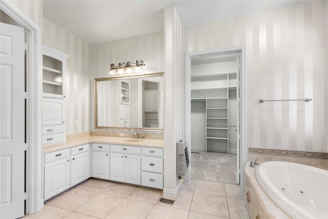 full bath featuring vanity, heating unit, a spacious closet, and wallpapered walls