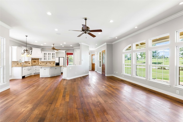 unfurnished living room with recessed lighting, dark wood-type flooring, a ceiling fan, visible vents, and baseboards