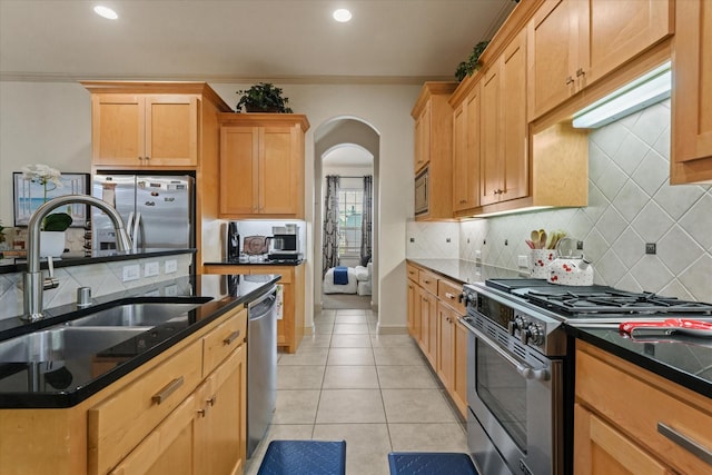 8405 Moore St, Frisco, TX 75034 - kitchen with built in appliances, arched walkways, a sink, and backsplash