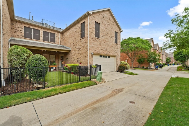 8405 Moore St, Frisco, TX 75034 - traditional-style home featuring driveway, a fenced front yard, a front yard, a garage, and brick siding
