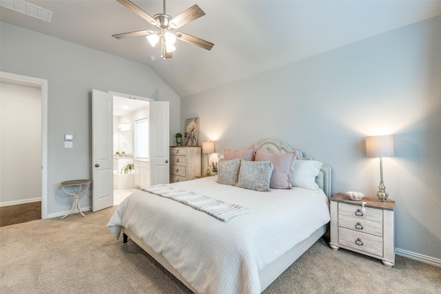 bedroom with visible vents, carpet, baseboards, lofted ceiling, and ensuite bathroom