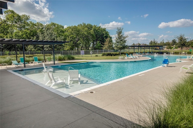 community pool featuring fence and a patio area