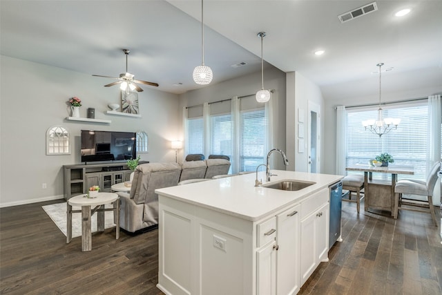 kitchen featuring a sink, visible vents, baseboards, dishwashing machine, and dark wood-type flooring