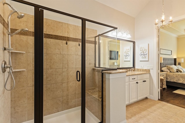 bathroom with ensuite bathroom, a stall shower, ornamental molding, vanity, and a notable chandelier