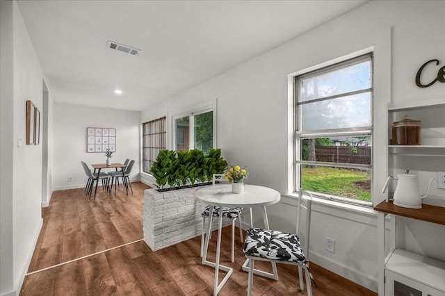 5409 Mallory Dr, Haltom City, TX 76117 - dining space featuring wood finished floors, visible vents, and a healthy amount of sunlight