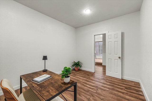 5409 Mallory Dr, Haltom City, TX 76117 - home office featuring baseboards and wood finished floors