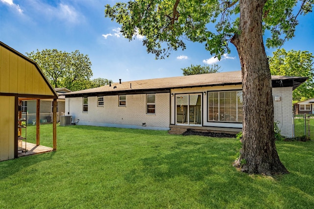5409 Mallory Dr, Haltom City, TX 76117 - back of property featuring central AC, brick siding, and a yard