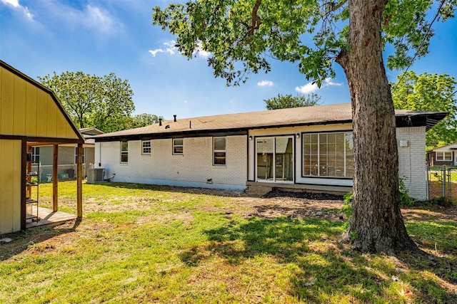 5409 Mallory Dr, Haltom City, TX 76117 - back of property with a lawn, central AC unit, and brick siding