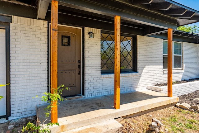 5409 Mallory Dr, Haltom City, TX 76117 - view of exterior entry featuring brick siding and a porch