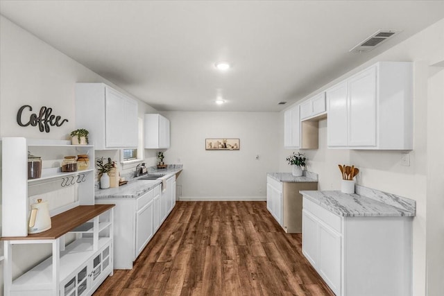 5409 Mallory Dr, Haltom City, TX 76117 - kitchen featuring dark wood-style floors, visible vents, white cabinetry, and baseboards